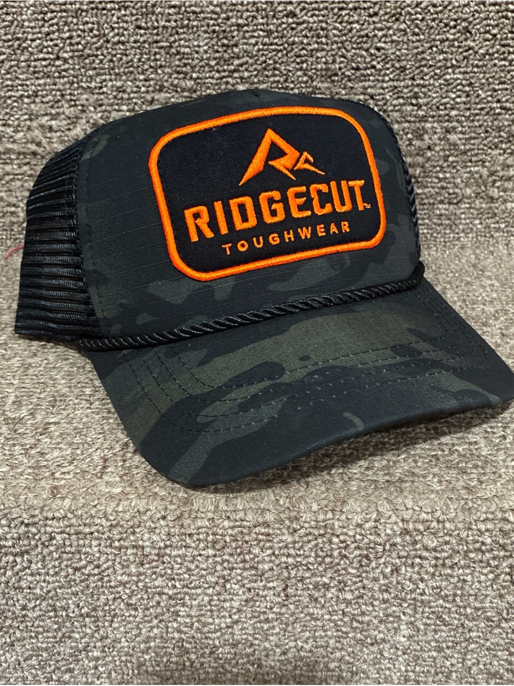Men's Ridgecut Black Camo Trucker Hat with Orange Patch